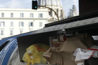 Trash overflows from garbage bins, in Rome, in this photo taken on Wednesday, Jan. 17, 2018. On March 4, Italians will cast ballots for Parliament, a national election that will also help determine their new government. Rome's mayor isn't running at all, but that detail hasn't stopped politicians from transforming the city's chronic trash problem into a big campaign trail issue. (AP Photo/Gregorio Borgia)
