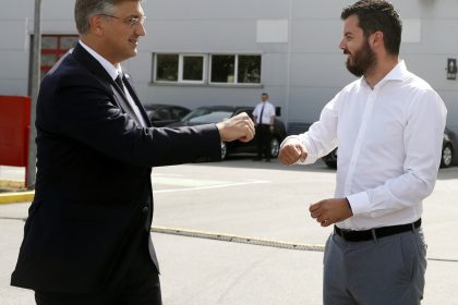Mate Rimac, right, head of Rimac Automobili electric supercar manufacturer greets Croatia's Prime Minister Andrej Plenkovic at his campus in Sveta Nedelja, near Zagreb, Croatia, moments before a visit of European Commission president Ursula von der Leyen, Thursday, July 8, 2021. Rimac Automobili recently took over the iconic French manufacturer Bugatti in a deal that is reported to be worth millions of euros. (AP Photo)
