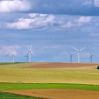 Rural landscape with wind turbines of wind farm amongst fields