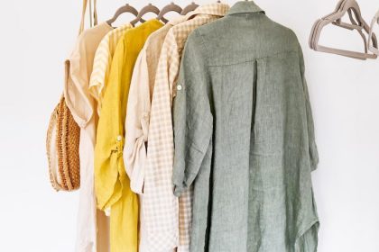 Linen clothes on gray hangers on the clothes rack. Slow Fashion. Conscious consumption. Crisis in the fashion industry, retail. Eco-friendly, Sustainable seasonal Sale concept. Zero waste.