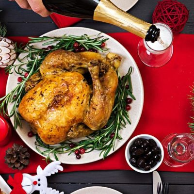 baked-turkey-christmas-dinner-the-christmas-table-is-served-with-a-turkey-decorated-with-bright-tinsel-and-candles-fried-chicken-table-family-dinner-top-view