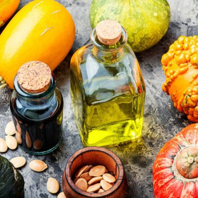 Pumpkin oil and raw pumpkin.Bowl of pumpkin seed oil,Image: 557403834, License: Royalty-free, Restrictions: , Model Release: no