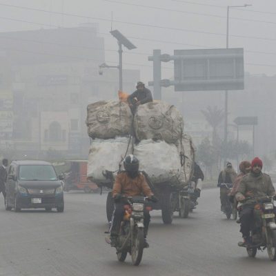 Pakistani citizens are busy in their routine life work during thick blanket of fog and smog in Lahore. Pakistani residents surprised due to the layer of dense Fog and smog which is causing problems in respiration, visibility and has also hampered smooth flow of traffic in provincial capital city Lahore,Pakistan on Jan. 20, 2022.,Image: 655986437, License: Rights-managed, Restrictions: *** World Rights ***, Model Release: no